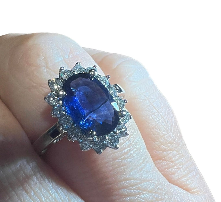 white gold sapphire ring surrounded by diamonds