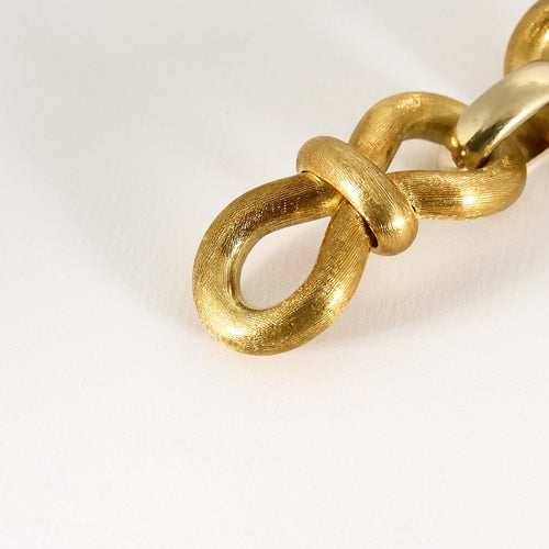 Flexible bracelet in brushed yellow gold and white gold 