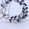 Broche Spilla vintage en or blanc 18 kt avec saphirs et diamants 58 Facettes SP9 '(00029)