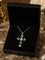 Cross-shaped pendant in gold, with emeralds and diamonds 