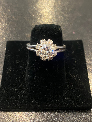 Solitaire ring in platinum with 0.85 ct diamond and diamond halo 
