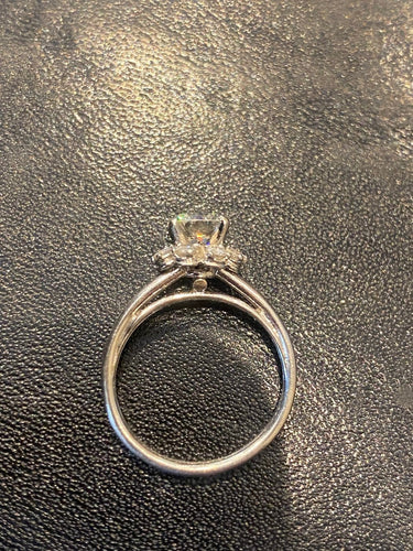 Solitaire ring in platinum with 0.85 ct diamond and diamond halo 