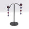 Boucles d'oreilles Signature - Boucles d'oreilles pendantes en or blanc 14K grenats rhodolites et tanzanites 58 Facettes