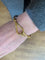 https://cdn.shopify.com/s/files/1/0647/1470/3075/files/Bracelet_Signe_-_Bracelet_Hermes_Jumbo_Dore_-_Joaillerie_Paris_-_Les_Pierres_de_Julie_6.jpg?v=1759752502
