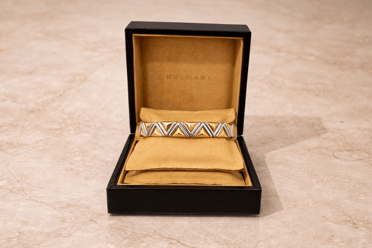 Bracelet Bvlgari Piramide - Bracelet jonc en or jaune et acier inoxydable 58 Facettes