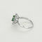 Bague 55 Bague Marguerite en or gris, émeraude et diamants 58 Facettes 260212