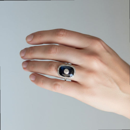 https://cdn.shopify.com/s/files/1/1015/8633/8124/files/antique-art-deco-platinum-sapphire-cocktail-diamond-halo-ring-worn.jpg?v=1783330036