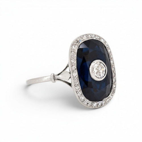 https://cdn.shopify.com/s/files/1/1015/8633/8124/files/antique-art-deco-platinum-sapphire-cocktail-diamond-halo-ring-left.jpg?v=1783330055
