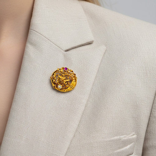 https://cdn.shopify.com/s/files/1/1015/8633/8124/files/antique-art-nouveau-18k-gold-chimera-brooch-ruby-diamond-worn.jpg?v=1783333395