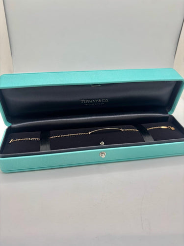 Bracelet Tiffany & Co T - Bracelet en or jaune 18K et diamants 58 Facettes 2134
