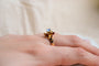 https://cdn.shopify.com/s/files/1/0963/7950/2920/files/Bague-de-fiancailles-ancienne-en-Or-jaune-18-carats-sertie-d_une-pierre-bleue-ciel_edc48a56-9cee-4ca5-b83e-c3c4f1585008.jpg?v=1779371116
