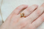 https://cdn.shopify.com/s/files/1/0963/7950/2920/files/Bague-de-fiancailles-ancienne-en-Or-jaune-18-carats-centree-d_une-Perle-entouree-de-pierres-rouges_d7604372-c7c2-40ca-aa10-939b41982b19.jpg?v=1779374046
