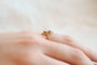 https://cdn.shopify.com/s/files/1/0963/7950/2920/files/Bague-de-fiancailles-Vintage-en-Or-jaune-18-carats-ornee-d_une-Perle-et-de-pierres-rouges_9122b698-007c-4de0-b99a-be0ea999e443.jpg?v=1779374048