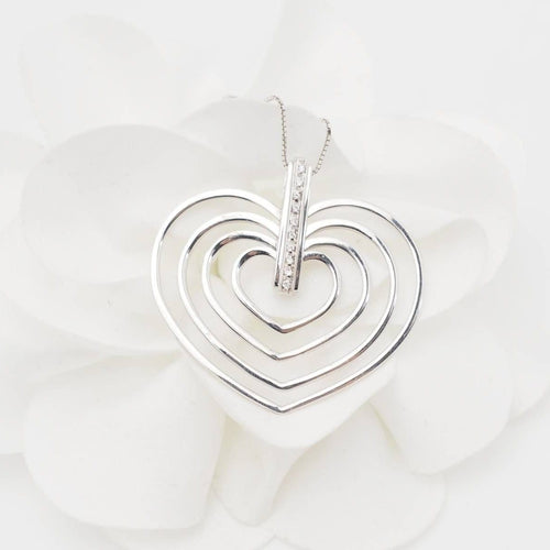 Collier Collier 4 cœurs en or blanc et diamants 58 Facettes 26383
