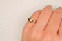 https://cdn.shopify.com/s/files/1/0963/7950/2920/files/bague-or-rose-18-carats-pierre-verte-diamants.jpg?v=1789719182