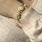 https://ledial.it/app/uploads/2025/02/36316-bracciale-oro-smalto-fiore-gabriella-rivalta-indossato_sito.jpg