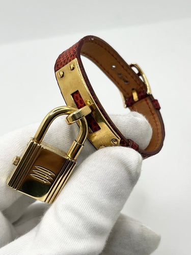 Montre Hermès Kelly - Montre à quartz plaquée or, cadran rouge 58 Facettes 2346