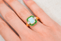 https://cdn.shopify.com/s/files/1/0963/7950/2920/files/bague-en-or-jaune-ornee-d-une-opale-rectangulaire-entouree-d-emeraudes-rondes-en-serti-rail-et-de-diamants-ronds-bague-mariage.png?v=1791882380