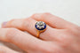 https://cdn.shopify.com/s/files/1/0963/7950/2920/files/bague-en-or-jaune-ornee-d-une-plaque-d-email-bleue-foncee-surmontee-de-diamants-et-d-oxydes-formant-une-etoile-bague-de-seconde-main.jpg?v=1791901344