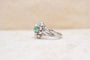 https://cdn.shopify.com/s/files/1/0963/7950/2920/files/bague-vintage-flocon-or-blanc-diamants-emeraude.jpg?v=1792577172