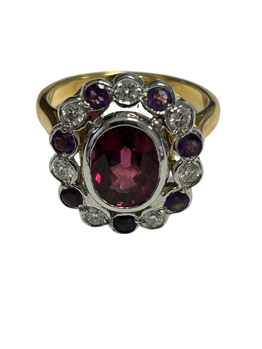 Oval scalloped 2-tone gold ring adorned with a rhodolite