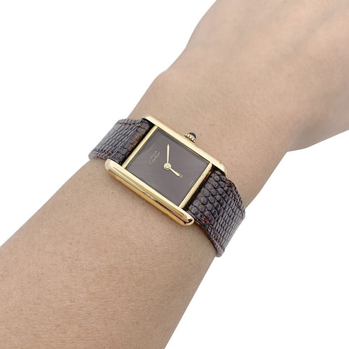 Montre Montre Cartier "Tank Must" argent plaqué or, cadran laqué marron. 58 Facettes 33542