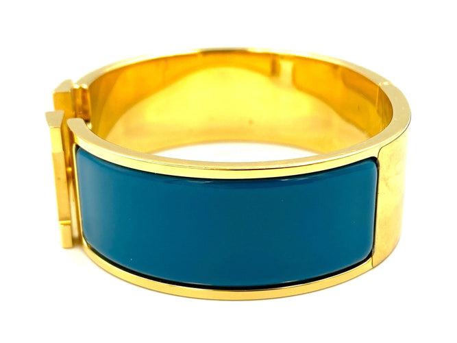 Bracelet HERMÈS. Bracelet métal doré et émail 58 Facettes