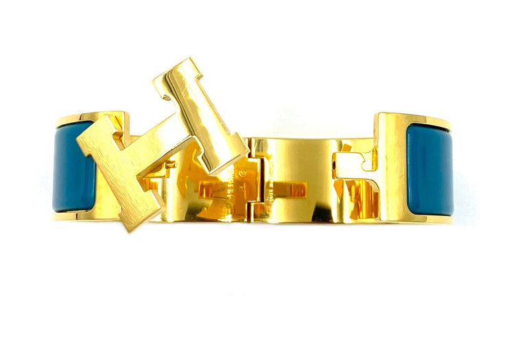 Bracelet HERMÈS. Bracelet métal doré et émail 58 Facettes