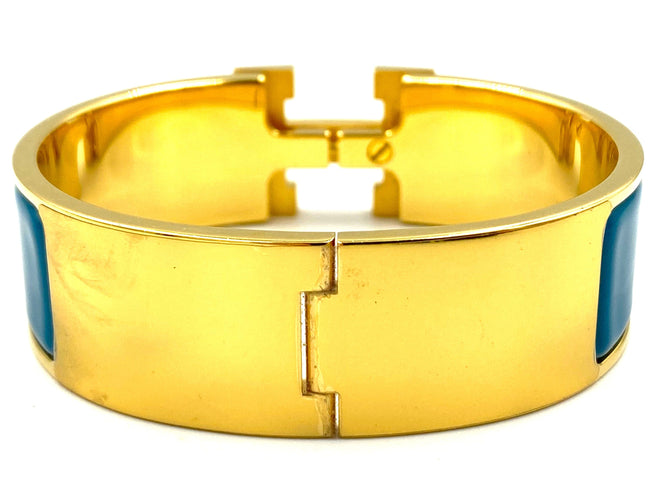 Bracelet HERMÈS. Bracelet métal doré et émail 58 Facettes