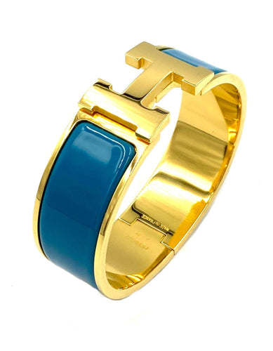 Bracelet HERMÈS. Bracelet métal doré et émail 58 Facettes